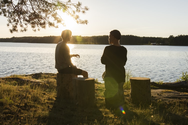 Two people talking outside.