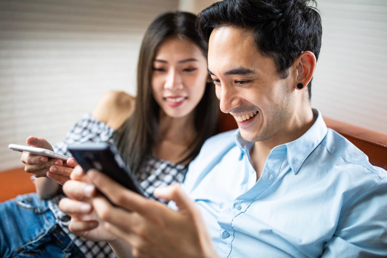 Man with hearing aid sits with his wife.